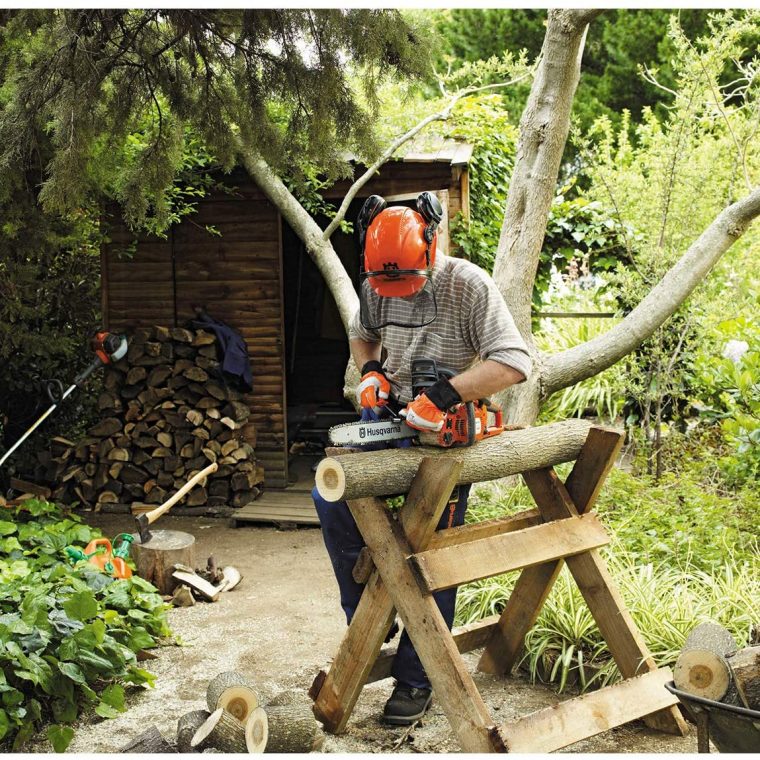 Man using Chainsaw to cut tree